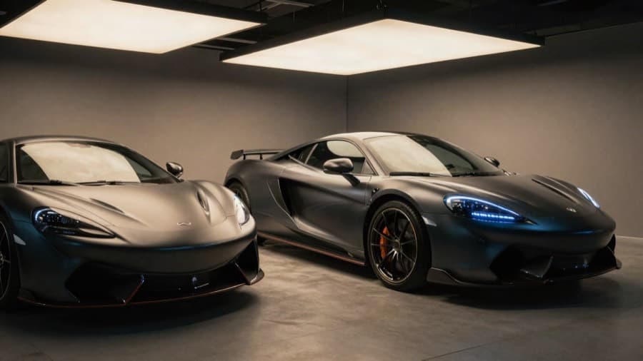 Matte black sports car under studio lights in a detailing bay